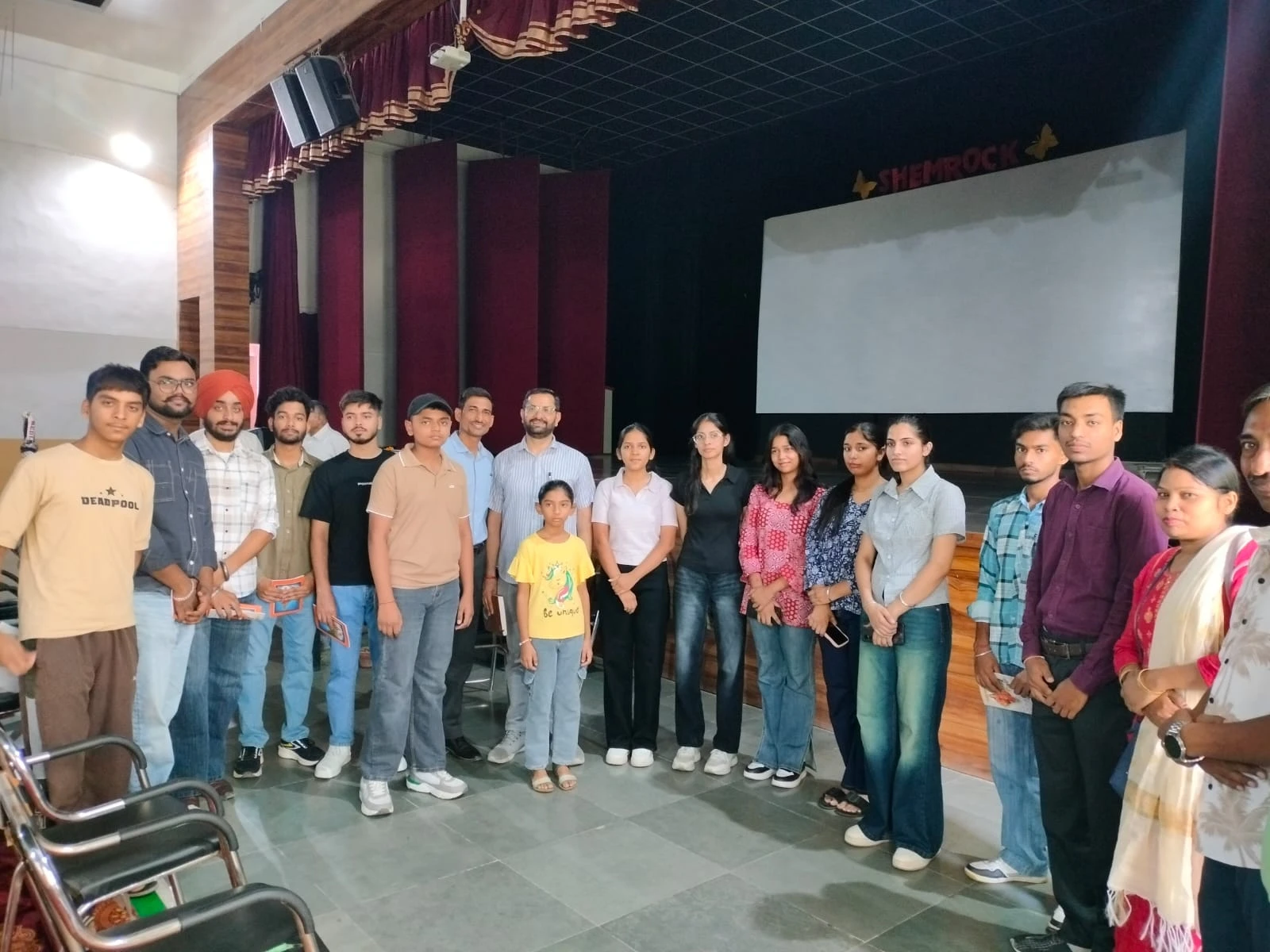 Volunteers and students gathered for a session in an auditorium