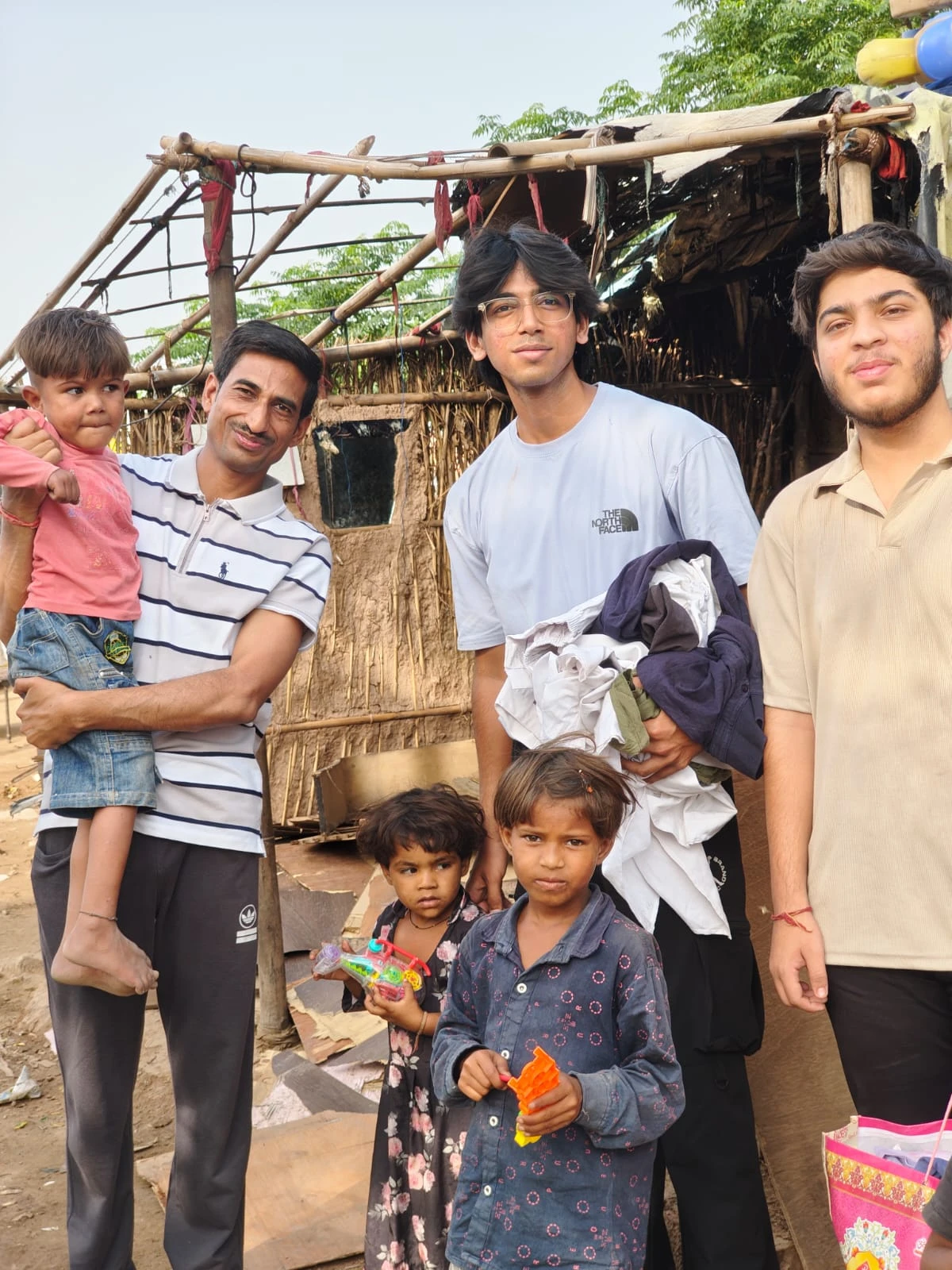 Volunteers sharing donated clothes with a family at a settlement