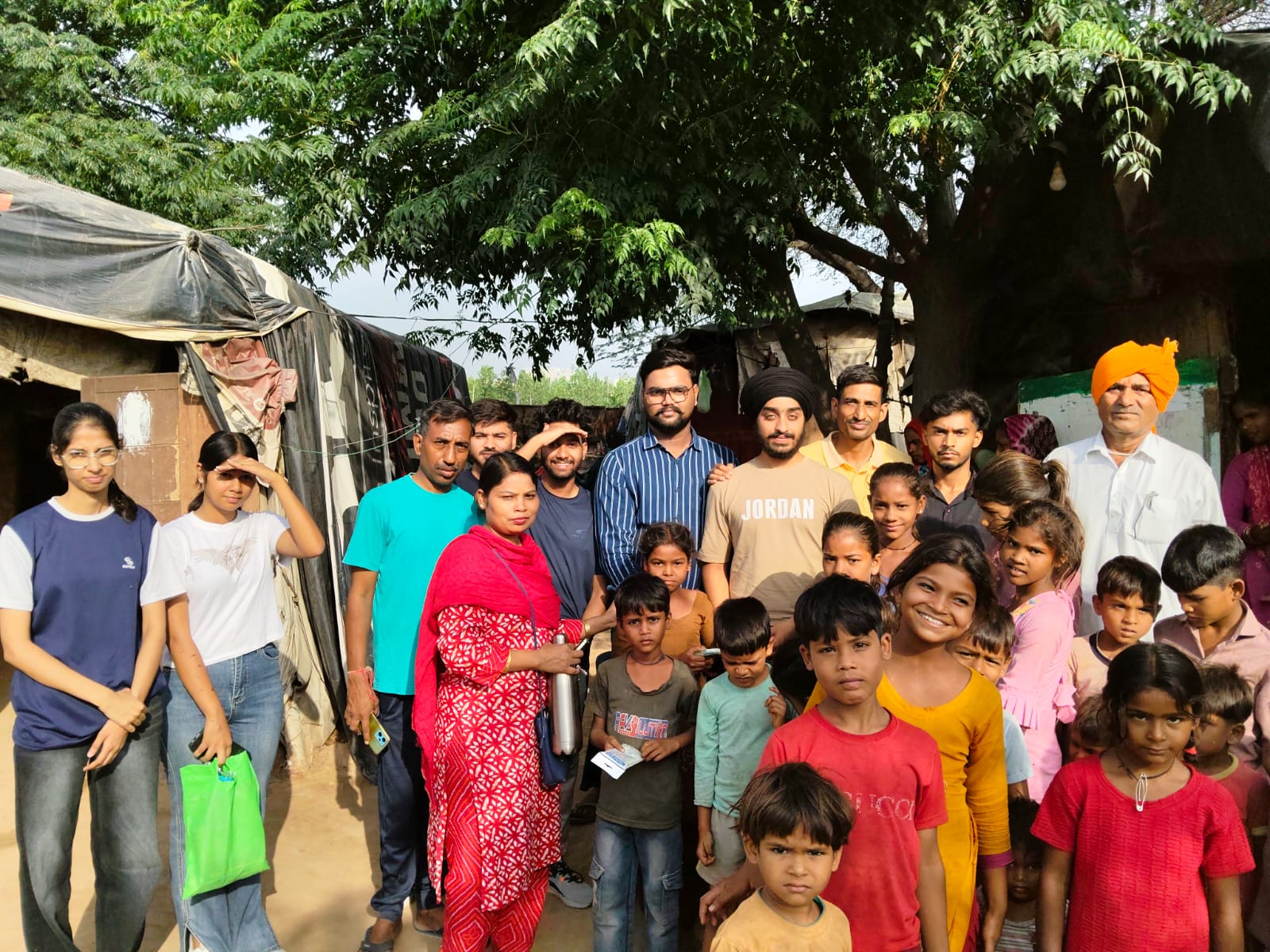 Volunteers and families together at a settlement visit