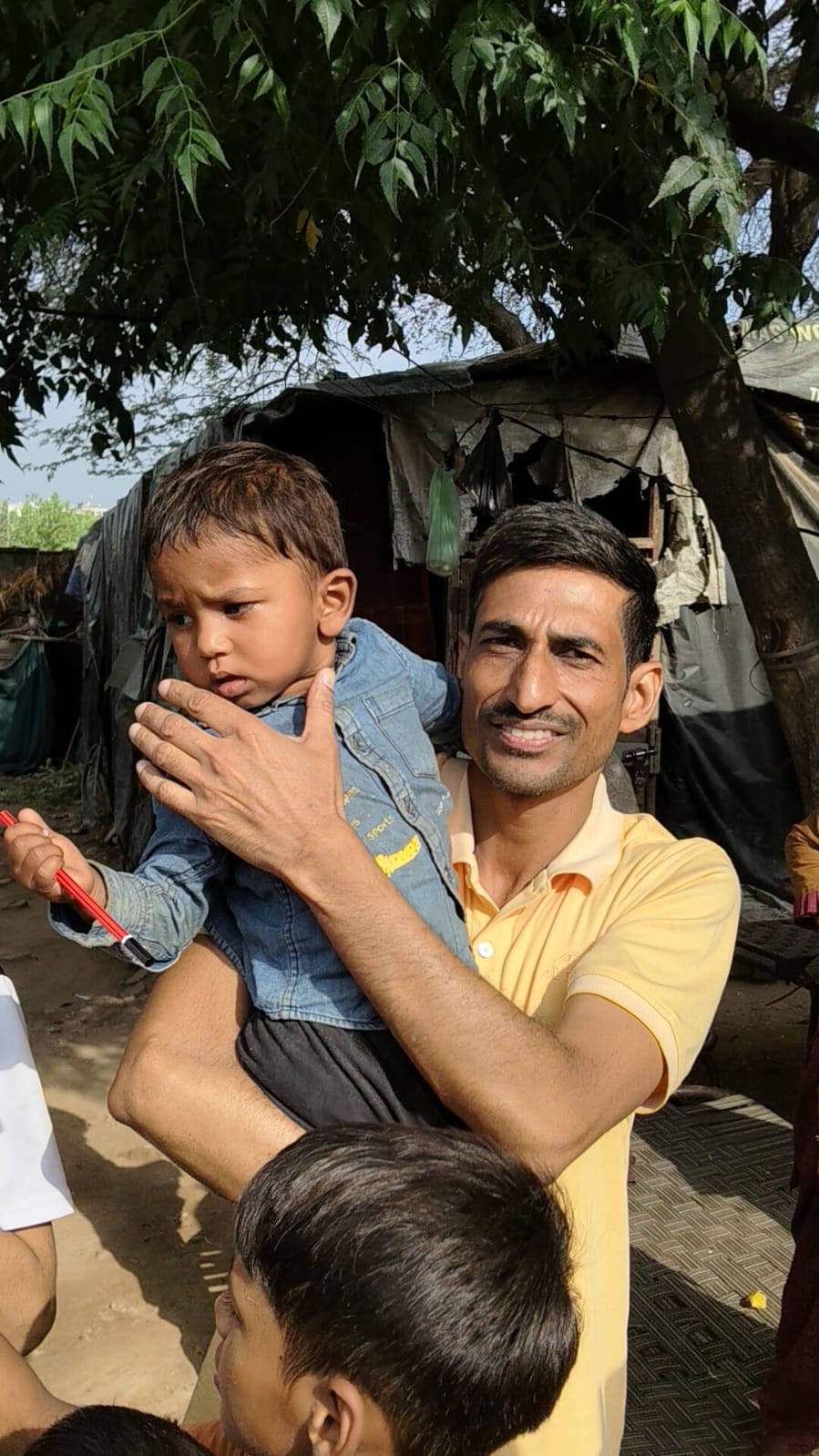 A volunteer with a young child during an outreach visit
